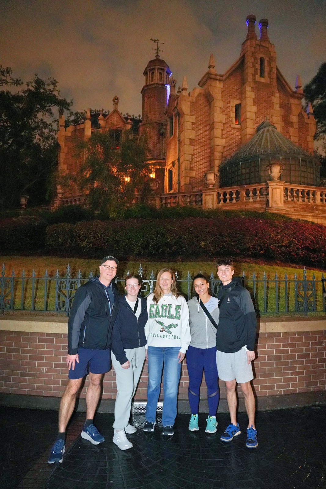 The Helmer family at the Haunted Mansion in Magic Kingdom at night