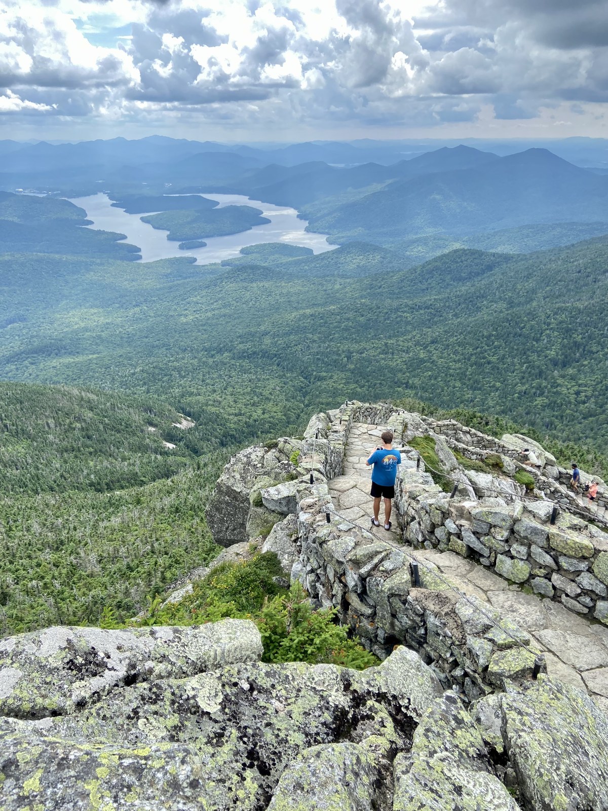 Cole at a rocky Adirondack summit overlooking the lake below