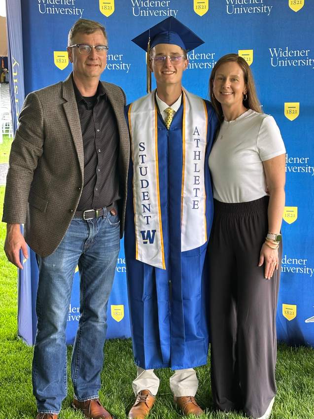 Cole at graduation with his parents