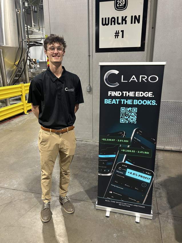 Cole with the CLARO banner