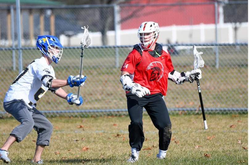Cole playing lacrosse as a youth