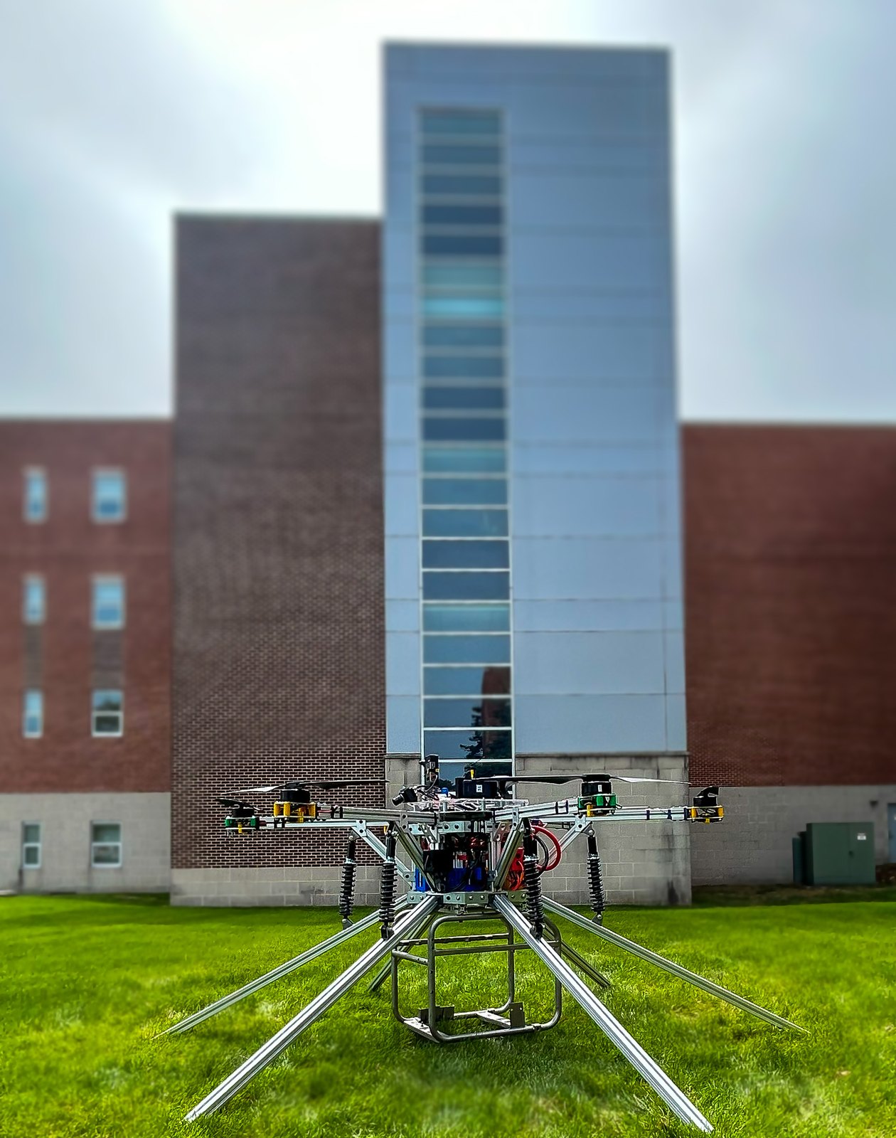 Skywalker III on the field in front of a campus building